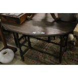 A 19th century oak gate leg table with bamboo effect supports and stretchers.