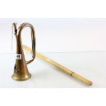 A copper and brass military bugle with special service group badge, together with a bamboo swagger
