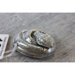 A silver snake vesta case