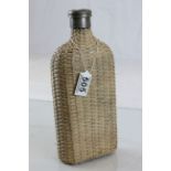 A wicker covered spirit flask