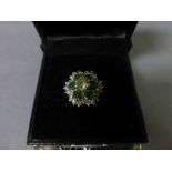 An 18ct yellow gold emerald and diamond cluster ring