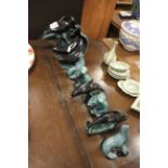 Quantity of Poole pottery dolphin and seal figures.