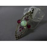 A silver Art Deco style ring set with garnets and a central opal