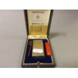 A cased vintage Dunhill 70 lighter with paperwork and accessories