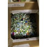 A large quantity of glass marbles in two boxes.