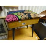 A vintage oak sewing box with upholstered top