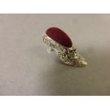 A silver pin cushion in the form of a shoe