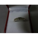 An 18ct diamond ring with brilliant cut central stone and baguette diamond shoulders