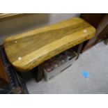 A heavy rustic wooden pig bench