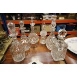 Six vintage cut glass decanters with stoppers