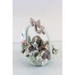 Lladro model of three puppies in a basket