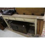 A vintage painted kitchen table with two drawers and scrubbed top