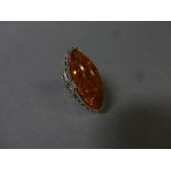 A substantial silver and amber style ring