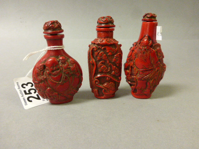 Three Oriental Cinibar snuff bottles