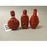 Three Oriental Cinibar snuff bottles