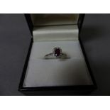 An 18ct white gold ruby and diamond ring of 40 points