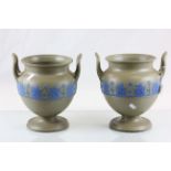 Pair of twin handled Wedgewood urns with impressed marks to base
