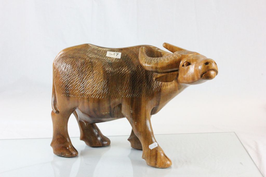 A well carved heavy wooden water buffalo