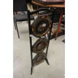 Early 20th century Black Lacquered Three Tier Cake Stand, the trays with handpainted floral scenes