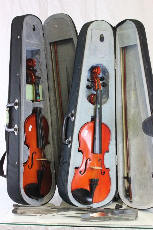 Two Modern Violins in Cases and a Folding Music Stand