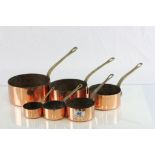 Set of Six Copper Graduating Saucepans with Brass Handles