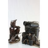 A good quality hardwood carved figure of a tribal man.and two pairs of carl Zeiss binoculars.