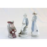 Three ceramic figures to include; Lladro boy with toy boat numbered 4, Nao girl with puppy