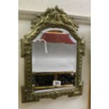 Ornate Brass Framed Bevelled Edge Mirror, the embossed frame with Cherub Design, probably Late