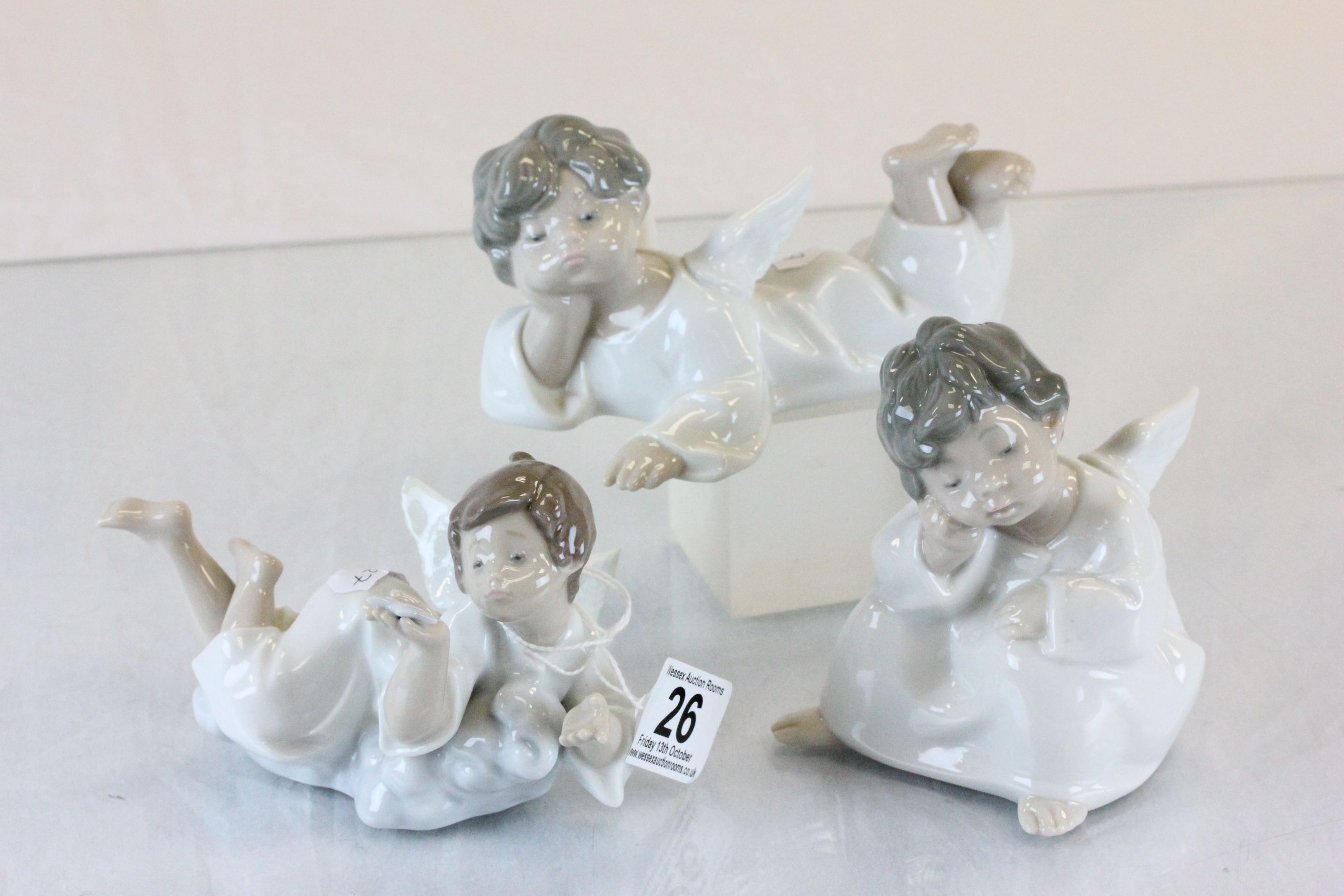 Three Lladro figures of angels at rest