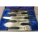 Horn handled cased carving set with silver collars to include fish servers