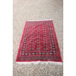 Red Ground Rug with Geometric Patterns