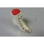 Silver pincushion in the style of a Ladies lace up boot inset with Rubies