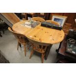 Pine Oval Extending Dining Table together with Four Lathe Back Kitchen Chairs