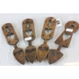 Four carved wooden Welsh style loving spoons