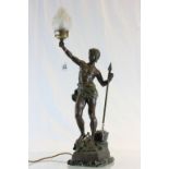 Art deco spelter lamp with flame glass shade modelled as a partially dressed model with spear and