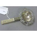 Chinese hallmarked Silver tea strainer with pierced floral decoration and a carved Jade handle