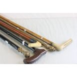 Five vintage walking sticks to include a malacca one with silver collar