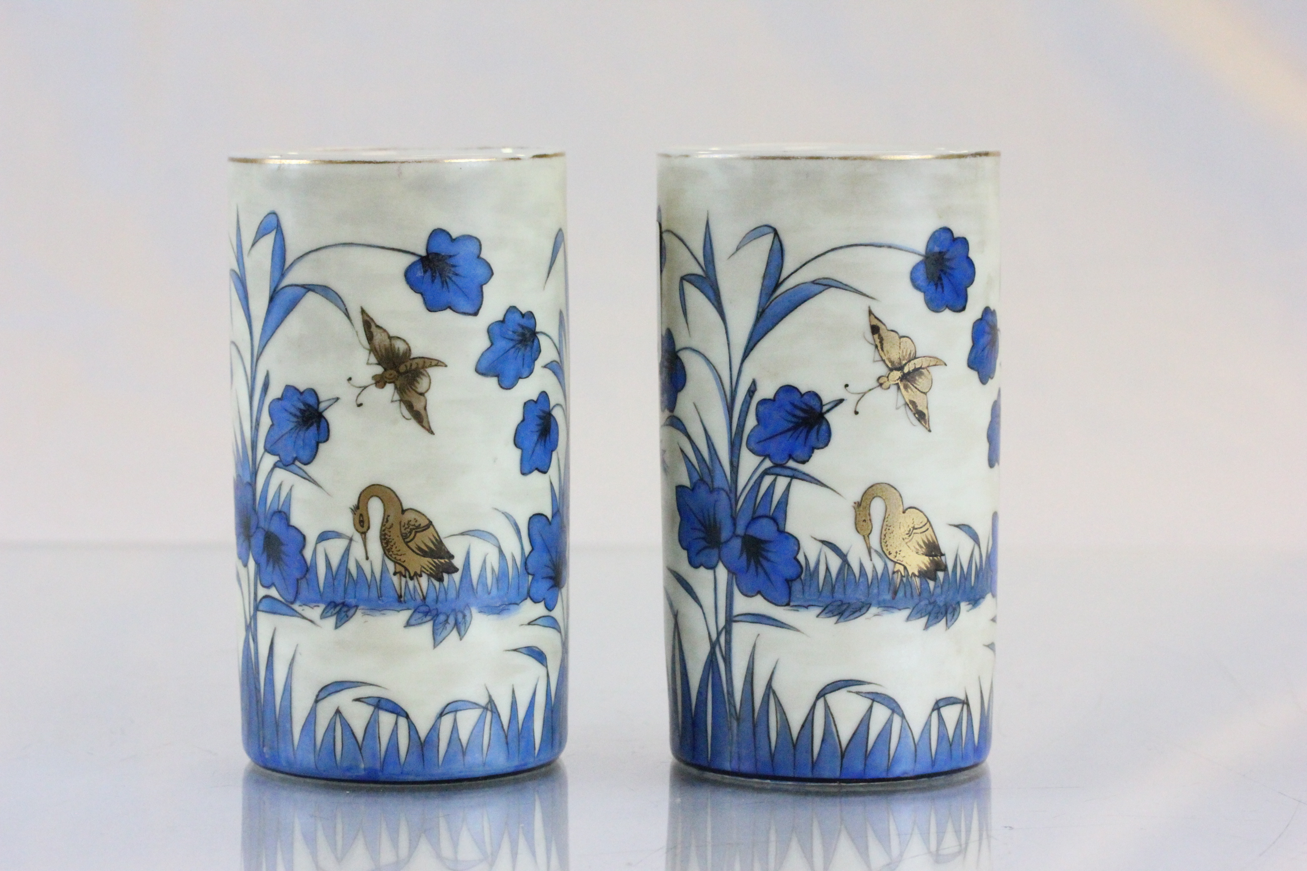 Pair of good late 19th/early 20th Century vases 11cm high, decorated in blue & gold colours,