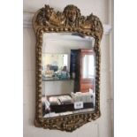 Ornate Gilt Framed Mirror moulded with mask of young girl and baskets of fruit, the mirror with