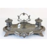 Cast brass ink stand with two inkwells and a bronzed finish