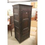 Jacobean Style Oak Panelled Cupboard, the single hinged door opening to reveal a modified interior