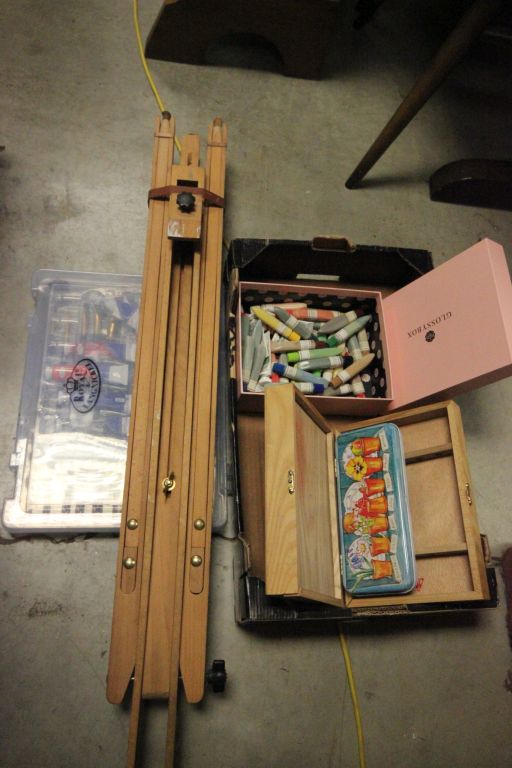 Box of artist materials including paints, easels, & brushes