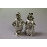 Pair of Novelty Pepper Pots, one in the form of a Young Boy and the other a Young Girl, tests as