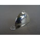 A silver vesta case in the shape of a jockeys cap