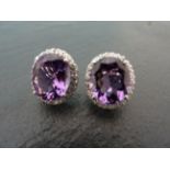 A pair of large silver CZ and amethyst cluster earrings