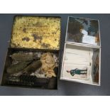 Gun cleaning kit in a vintage cigarette tin and a small collection of tea cards