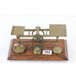 Set of Early 20th century Brass Postal Union Scales and Weights on Oak Plinth