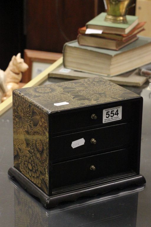 A Japanned laquer three drawer cabinet of small dimensions.