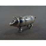 A silver pig vesta case