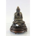 Bronze Buddha figure with an Oriental wooden stand